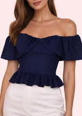Заредете изображението в програмата за преглед на галерия, Navy blue off-shoulder top worn by a model on a light pink background

