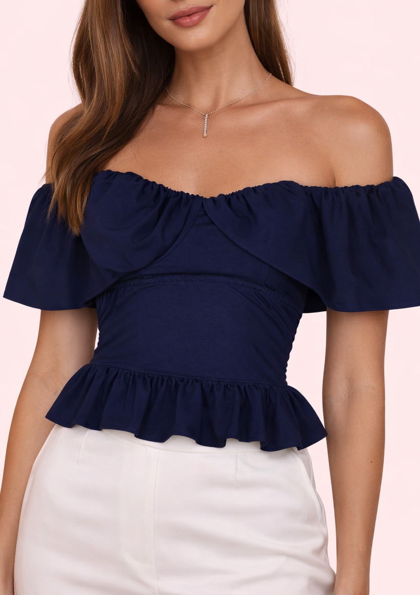 Navy blue off-shoulder top worn by a model on a light pink background
