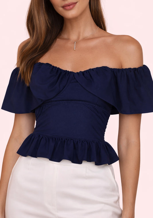 Navy blue off-shoulder top worn by a model on a light pink background