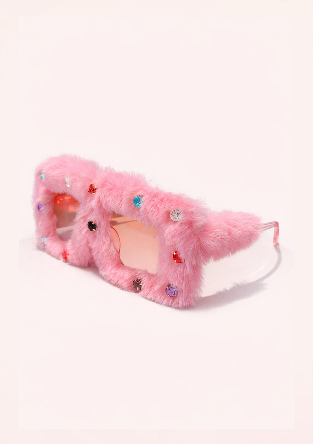 Pink fuzzy sunglasses with rhinestone embellishments on a white background
