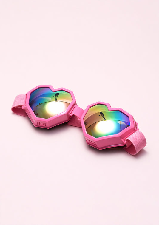 Pink goggles with colorful lenses on a white background