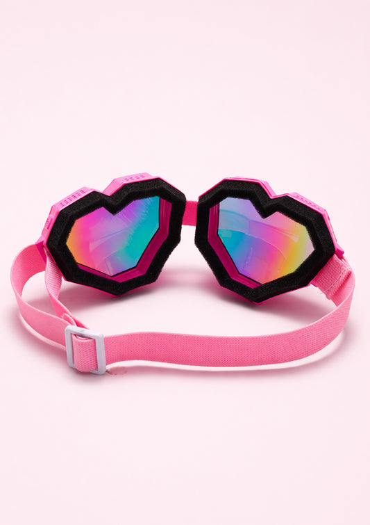 Pink goggles with heart-shaped lenses on a white background