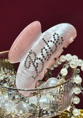Decorative hair clip with rhinestones and pearls on a red background