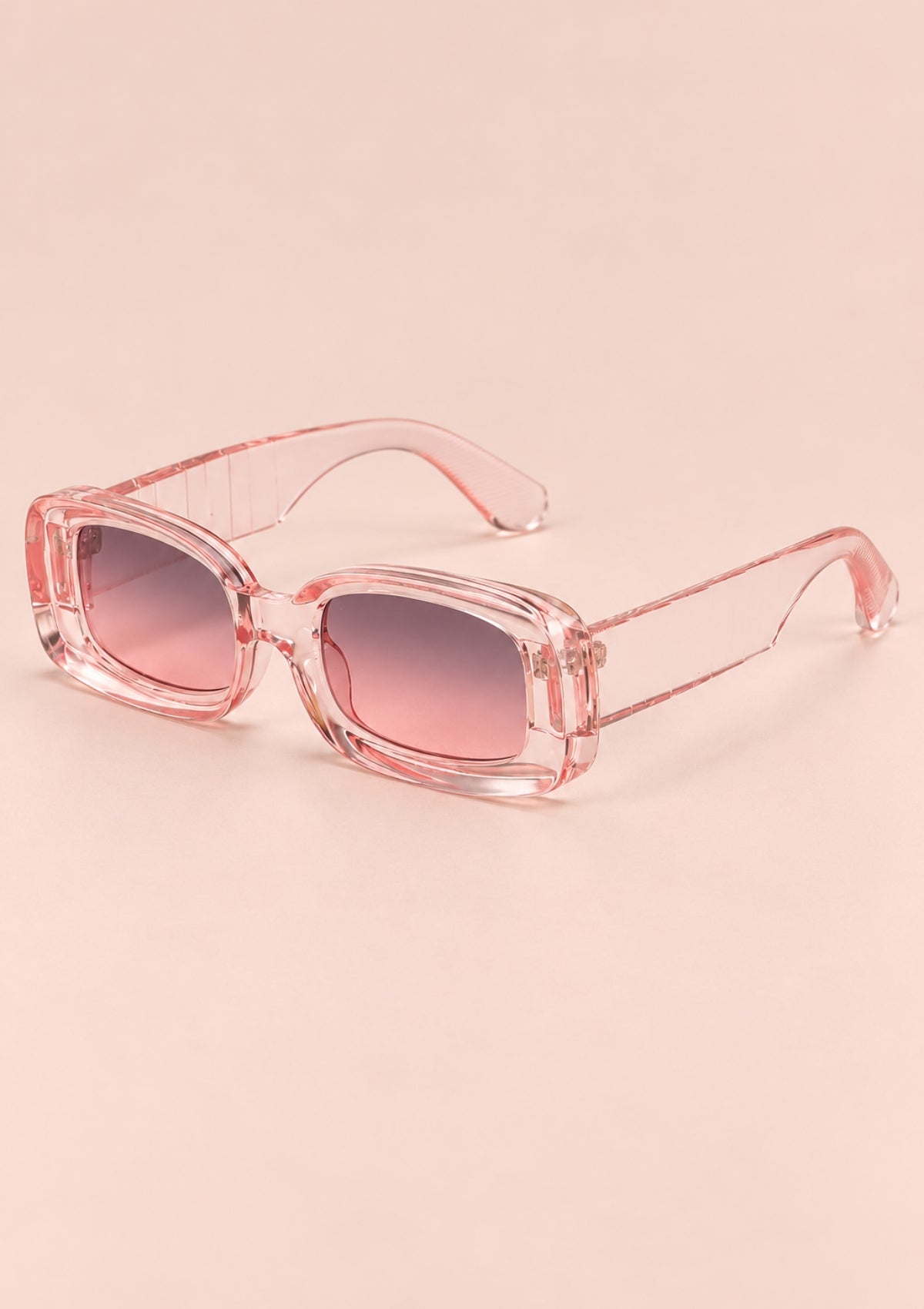 Pink rectangular sunglasses with a transparent frame and gradient lenses