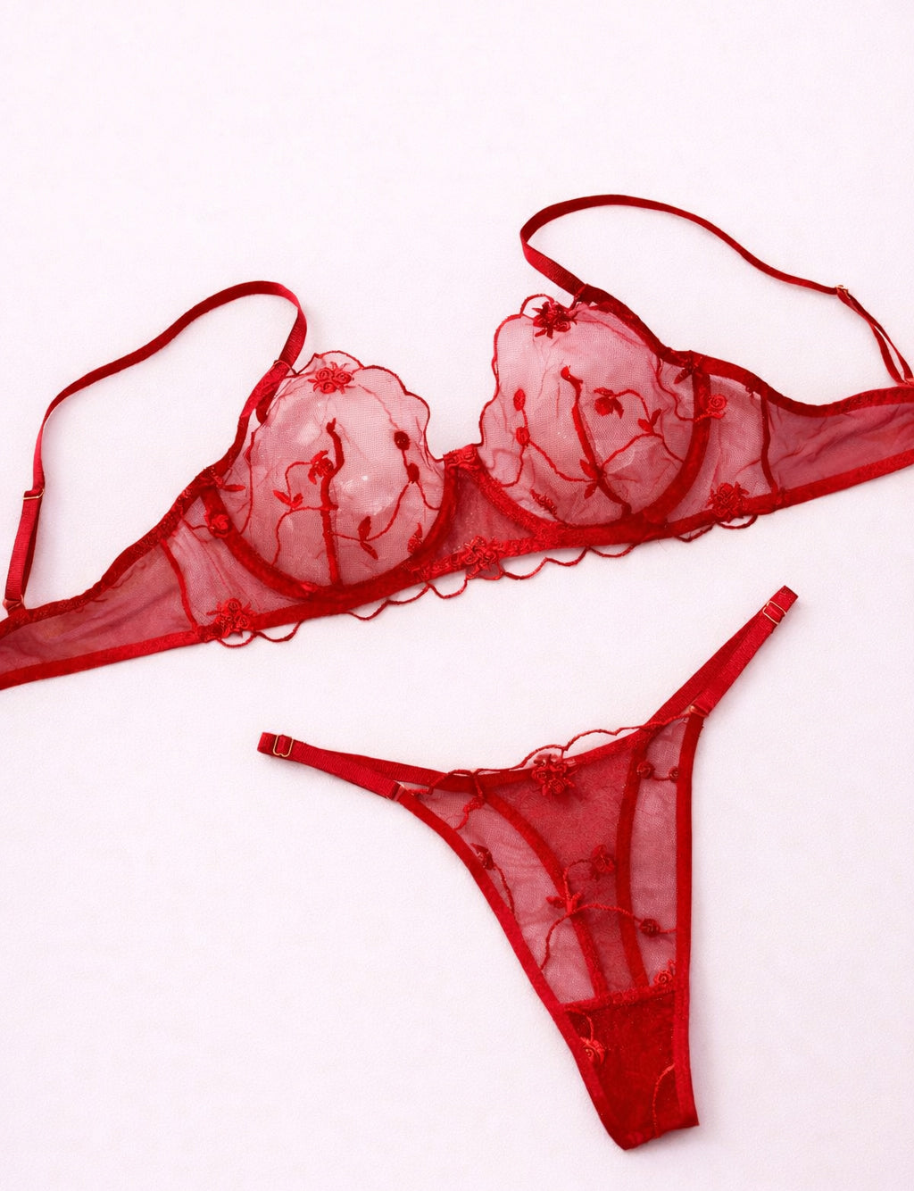 Red lace lingerie set on a white background