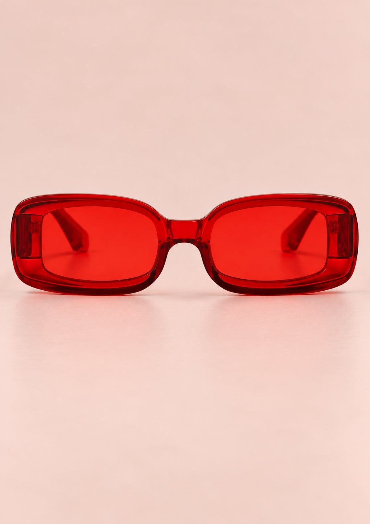 Red rectangular retro sunglasses with a translucent frame and red lenses