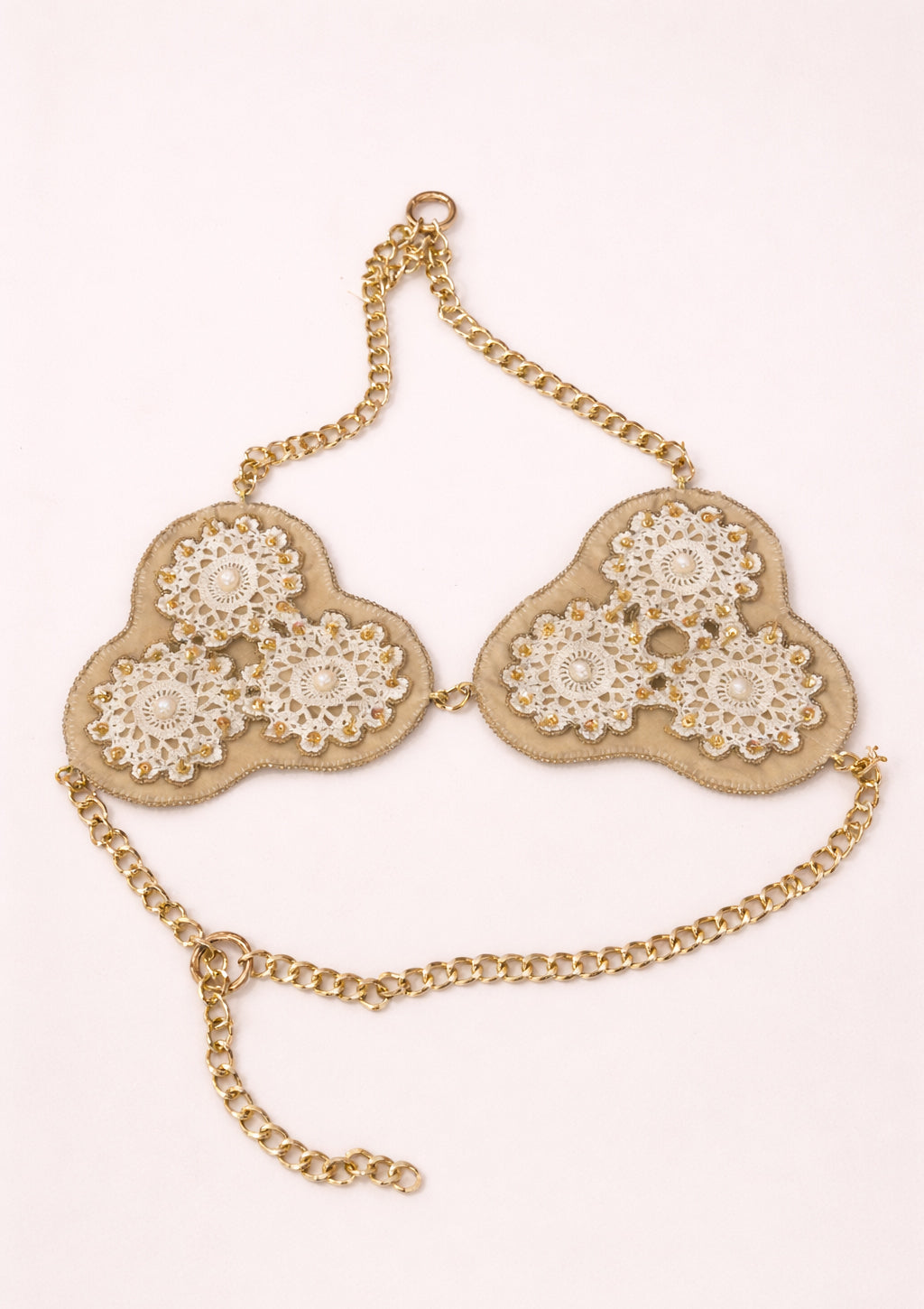 Gold chain top with floral designs on a white background
