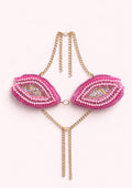 Pink beaded top with gold chain on a white background