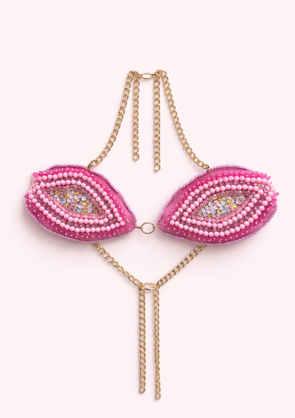 Pink beaded top with gold chain on a white background