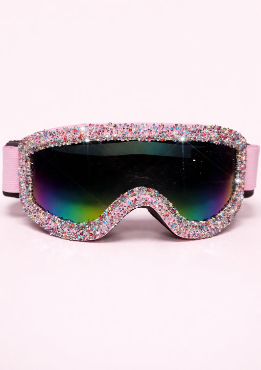 Sparkly goggles with pink frame and multicolored lenses on a white background
