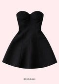 Black strapless dress on a light pink background with 'festival guru' branding.