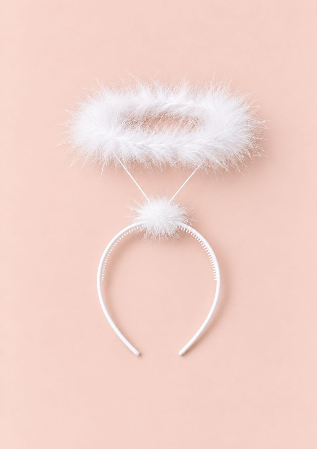 White angel headband with a fluffy white faux-fur halo and pom-pom, displayed on a solid pale peach-pink background.