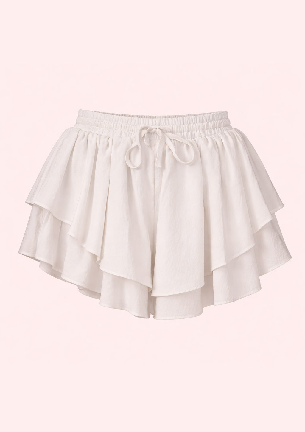 White shorts with ruffled layers on a light pink background
