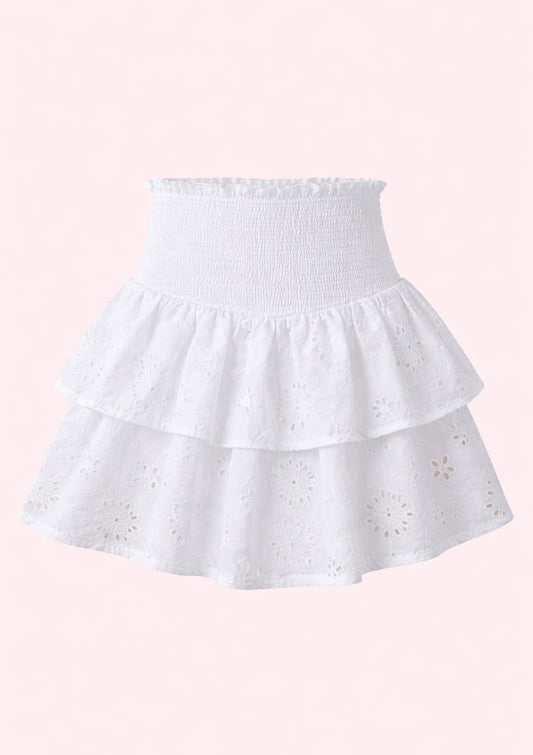 White tiered skirt with star patterns on a pink background
