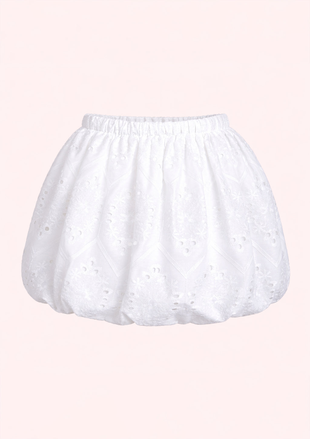 White skort with lace details on a pink background