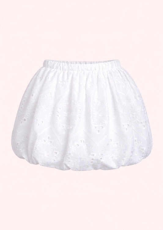 White skort with lace details on a pink background