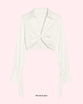 Load image into Gallery viewer, White sleeveless top with a bow detail on a light pink background

