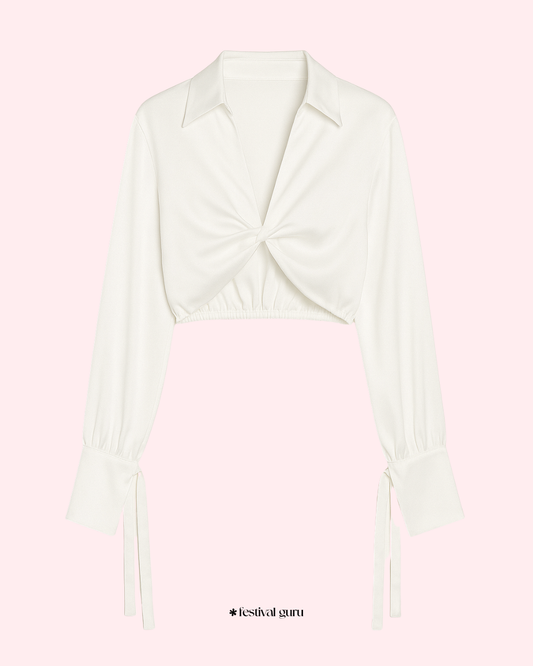 White sleeveless top with a bow detail on a light pink background