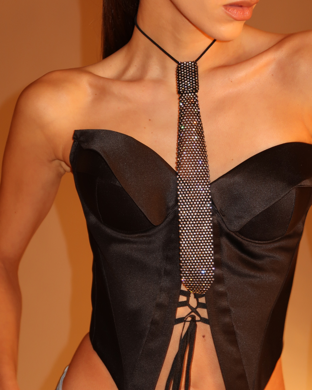 Black top with a detailed back tie on a blurred background