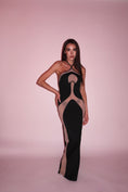 Load image into Gallery viewer, Model wearing a black and sheer dress against a pink background
