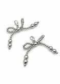 Заредете изображението в програмата за преглед на галерия, Silver bow-shaped shoe charm on a white background 
