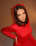Заредете изображението в програмата за преглед на галерия, Person wearing a red outfit with devil horns against a brown background
