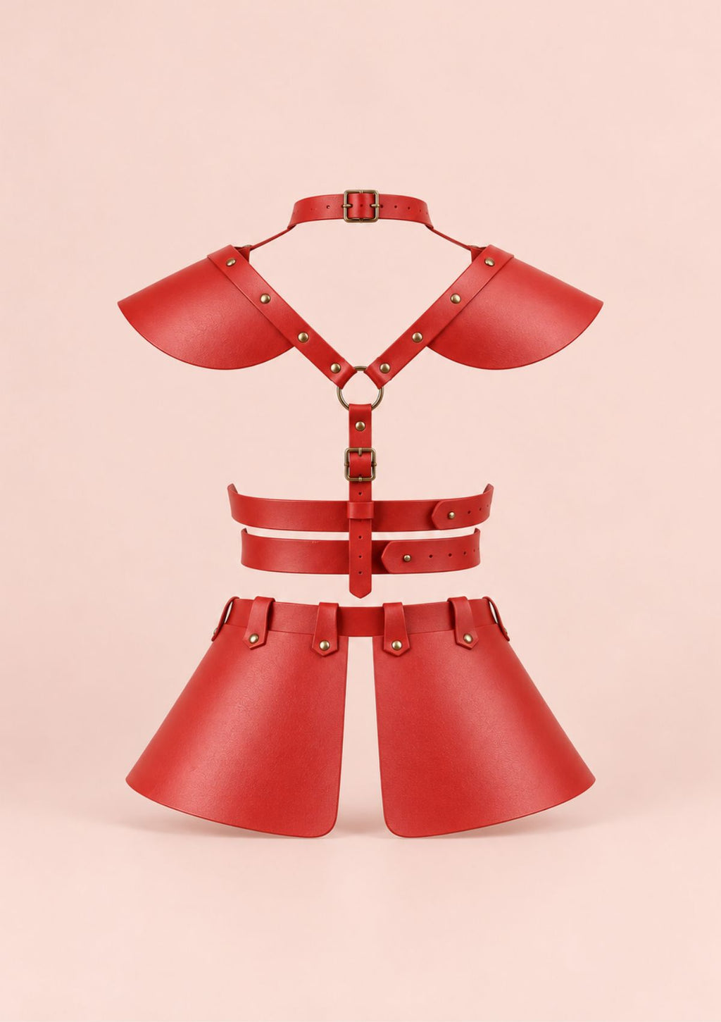 A red faux leather body harness set with shoulder guards, a cross-strap harness, waist straps, and a matching skirt, displayed on a solid pale pink background.