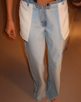 Заредете изображението в програмата за преглед на галерия, Light blue jeans with a white shirt underneath on a plain background
