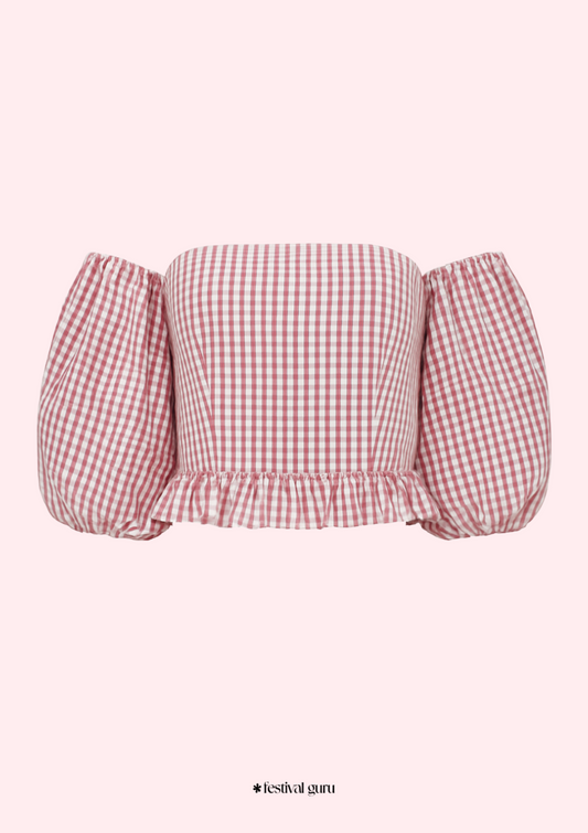Red and white checkered off-shoulder top on a pink background