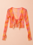 Заредете изображението в програмата за преглед на галерия, A long-sleeve sheer mesh crop top with a ruffled V-neckline and tie-front detail, featuring a vibrant orange, pink, and yellow tie-dye pattern, laid flat on a light beige background.
