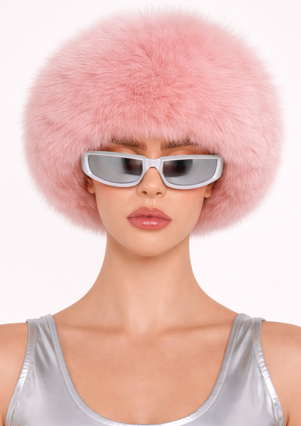 Person wearing a pink fur hat and silver sunglasses on a white background