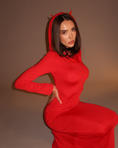 Заредете изображението в програмата за преглед на галерия, Person wearing a red dress with a hood and devil horns against a brown background

