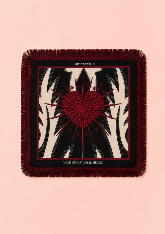 A square throw scarf with fringe edges, featuring a tarot card design of the 'Joy of Loves' card. The design has a dark red central heart and radiating lines over a black and cream zebra-stripe pattern, set against a solid pale pink background.