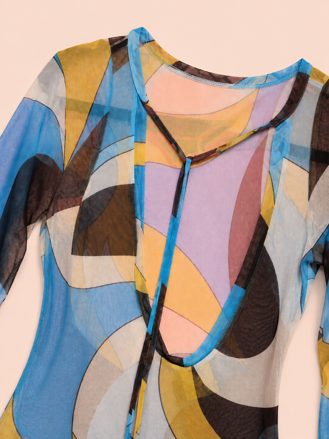 A sheer long-sleeve top with an abstract geometric print in blue, yellow, brown, pink, and gray, featuring a split neckline with tie-front closures.