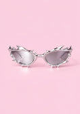Заредете изображението в програмата за преглед на галерия, Sunglasses with spike-like designs on a pink background
