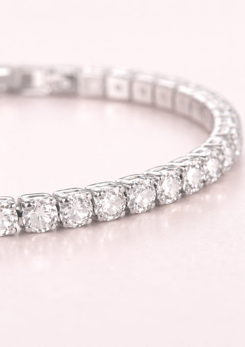 tennis bracelet on a light pink background