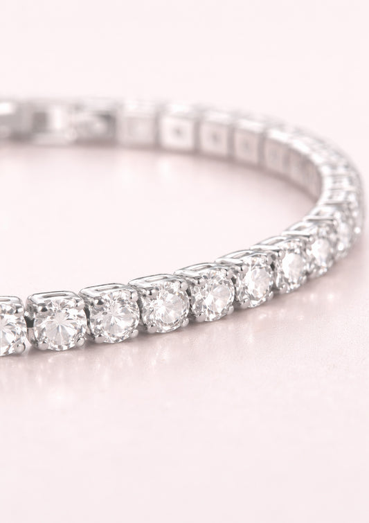 tennis bracelet on a light pink background